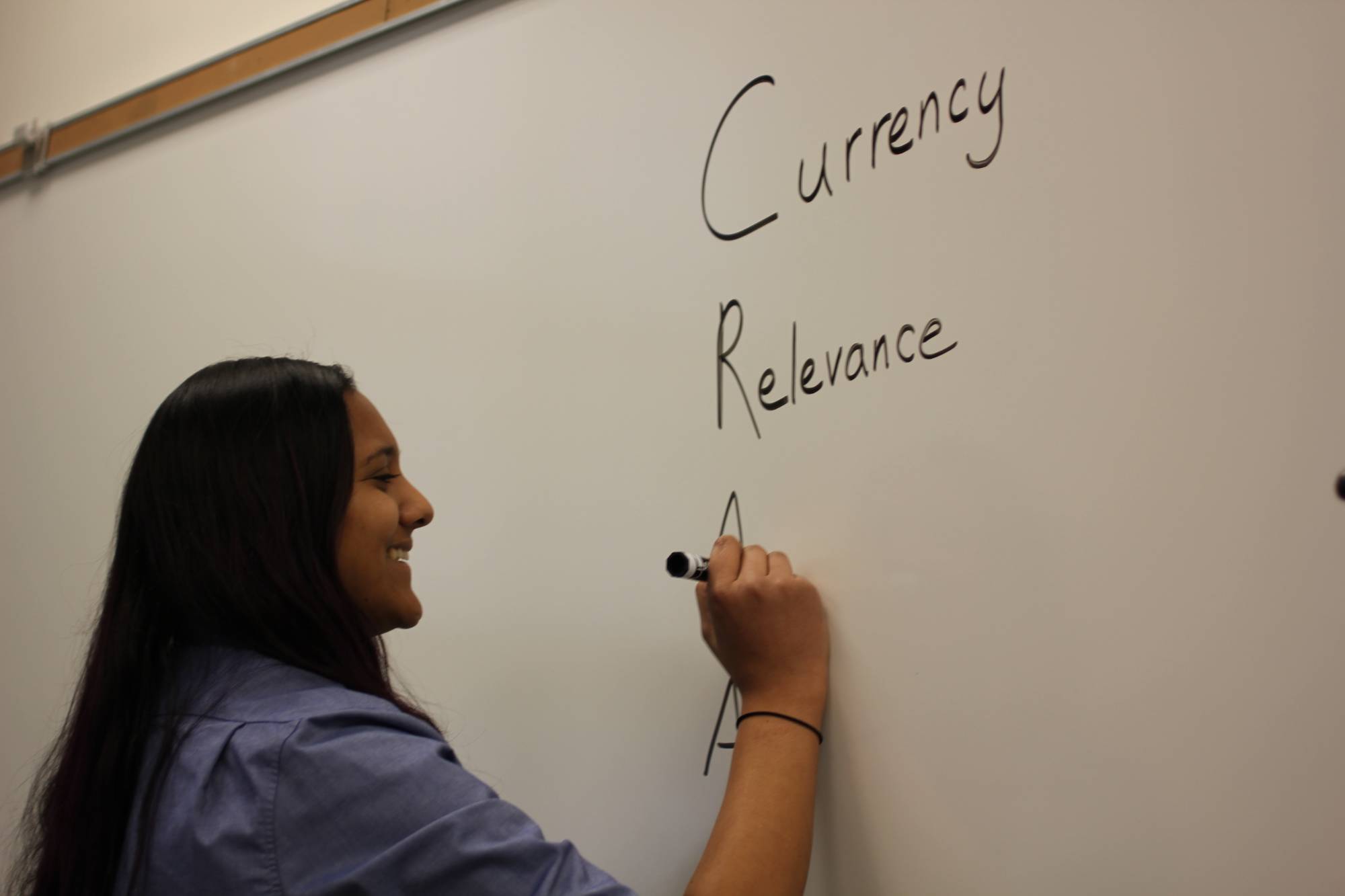 Preethi Gorecki uses a whiteboard